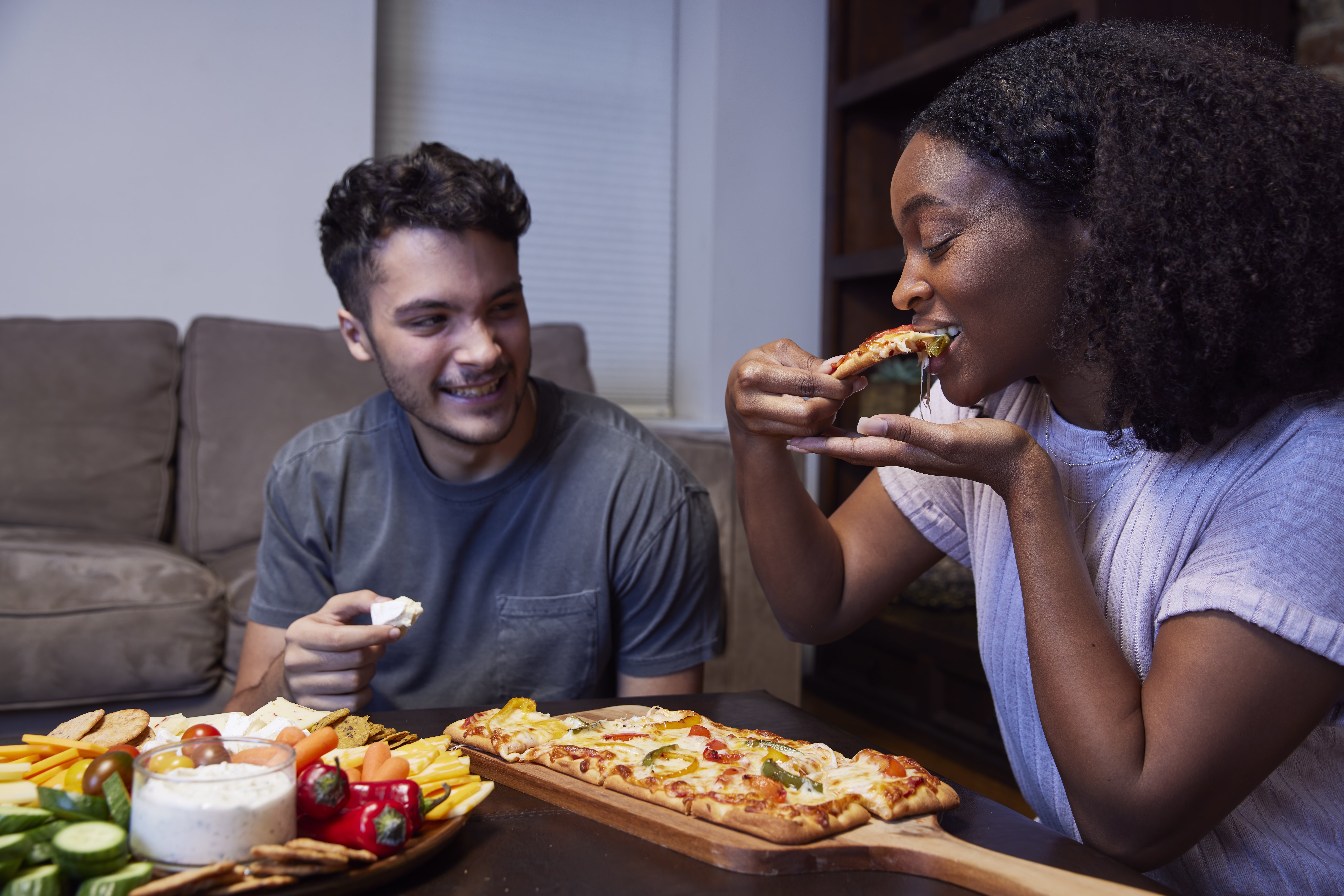 A couple eating pizza