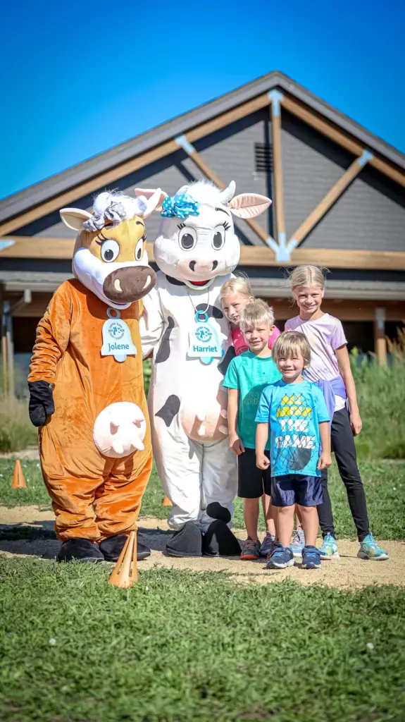 Dairy cow mascots with kids