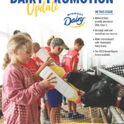 Dairy Promotion update magazine front cover. Girl feeding calf a bottle.