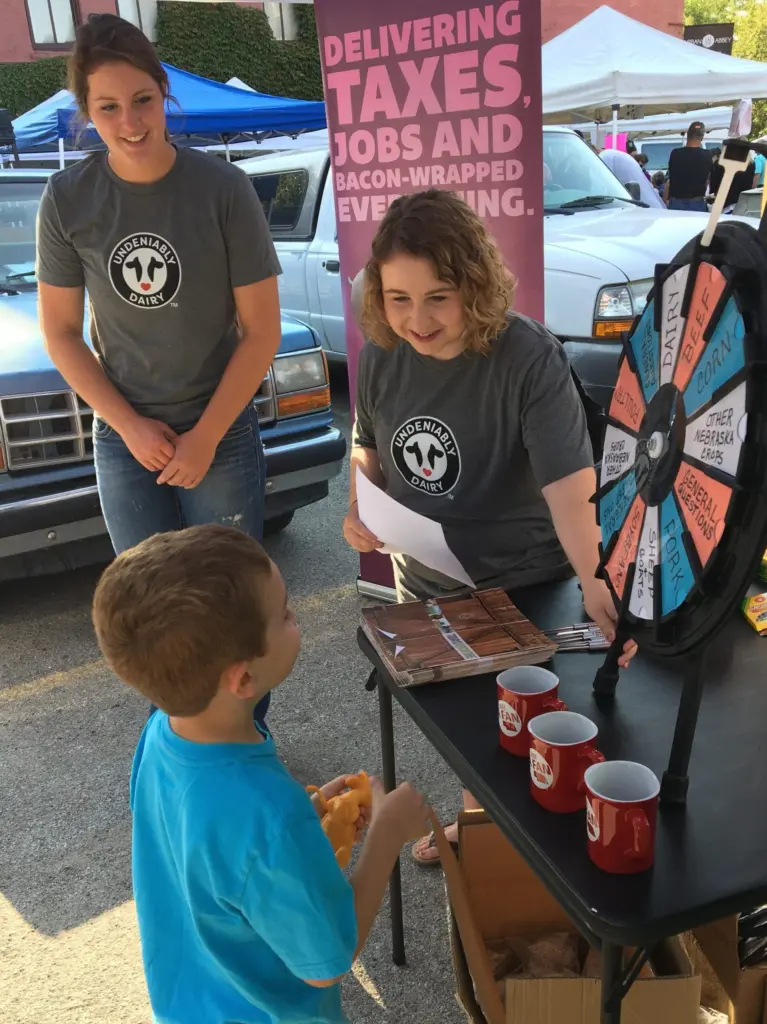 Two adults with a child, playing a game.