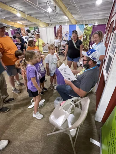 Dairy farmer reading to fairgoers at Kansas State Fair