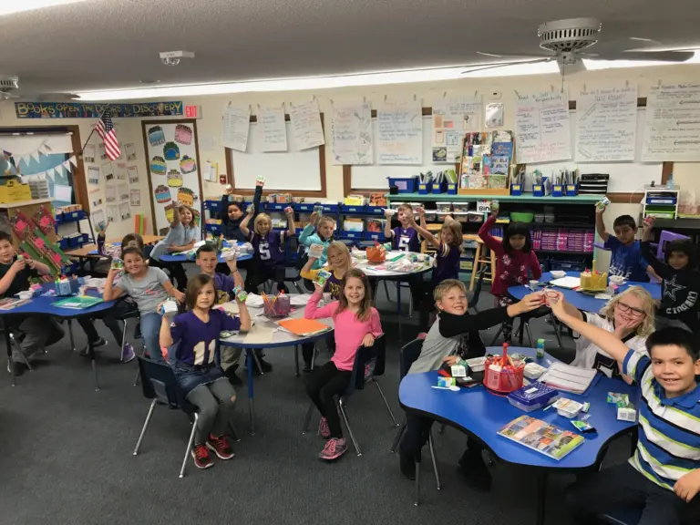 Kids in a classroom hold various dairy products aloft.