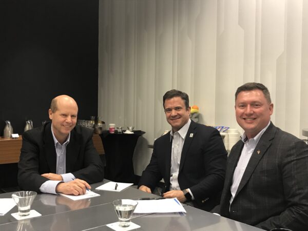Chad Vincent, Dairy Farmers of Wisconsin CEO, and Doug Ackerman, Dairy Alliance CEO, sit at a table with former Midwest Dairy CEO Lucas Lentsch.