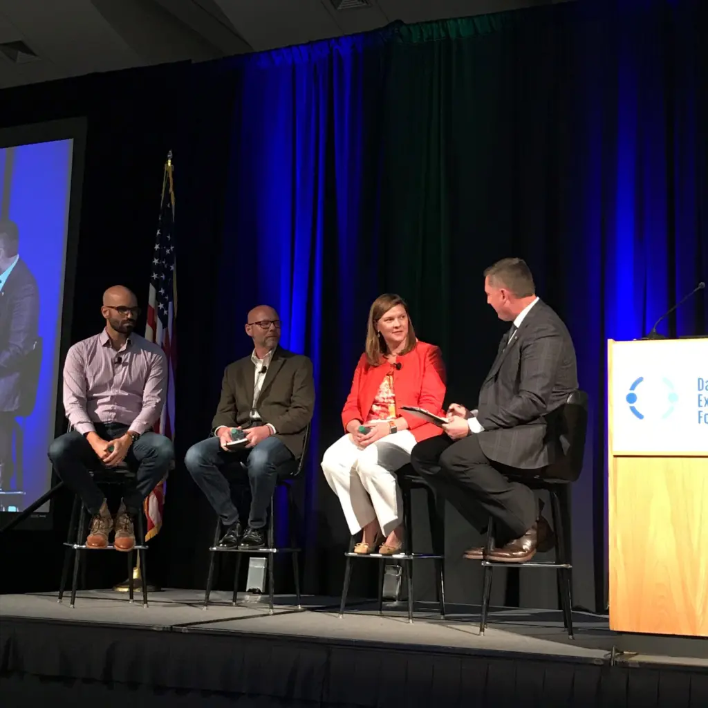 Former Midwest Dairy CEO Lucas Lentsch onstage, leading a panel discussion.