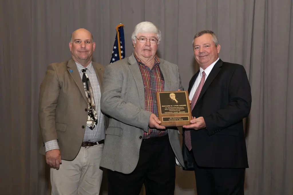 Missouri dairy farmer Bill Siebenborn, center, was presented with the Richard E. Lyng Award by National Dairy Board Chair Brad Scott, left, and National Milk Producers Federation Chair Randy Mooney.