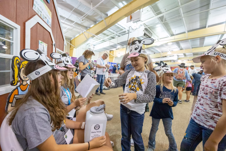 Group of little girls wearing paper cow hats at Kansas State Fair