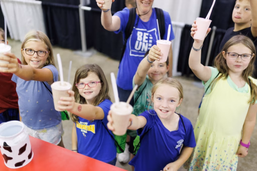 Group of children holding up milkshakes