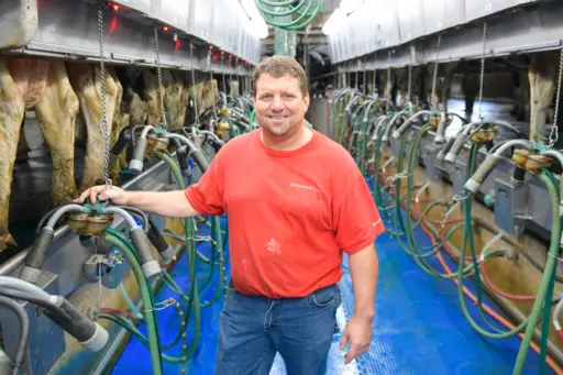 Dairy farmer Marty Burken stands in his milking parlour.