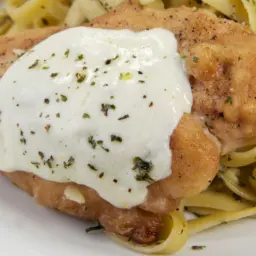 Oven baked chicken with melted mozzarella and garlic butter pasta.