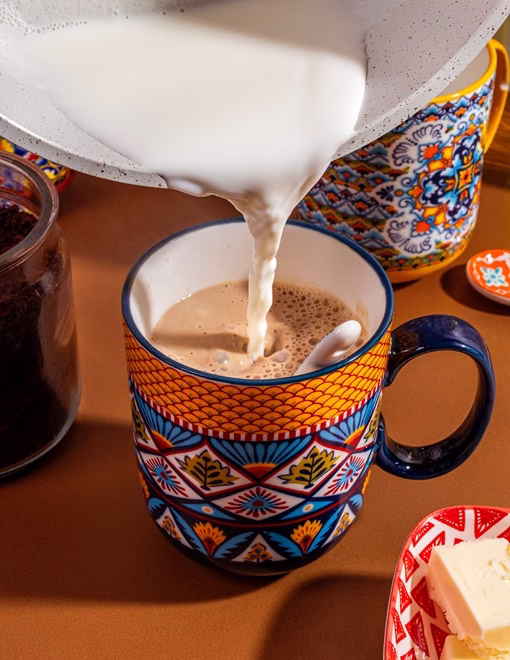 Milk being poured into cup