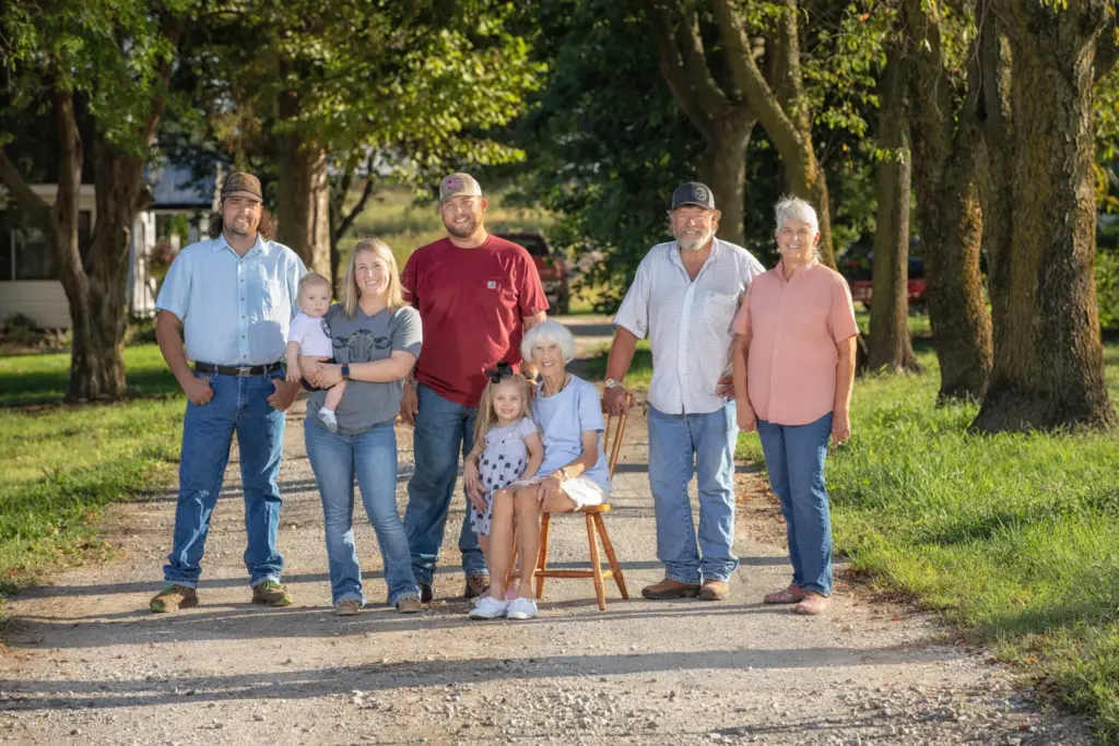 A farm family poses on their farm.