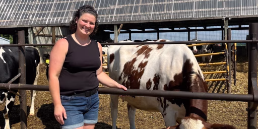 Amanda Zigan standing next to cows outside