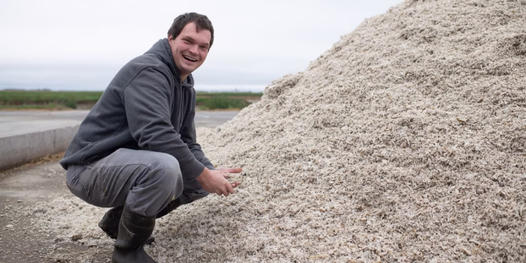 Man crouching and smiling in field