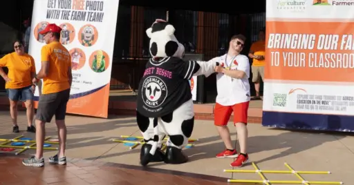 Person dancing with person in cow costume