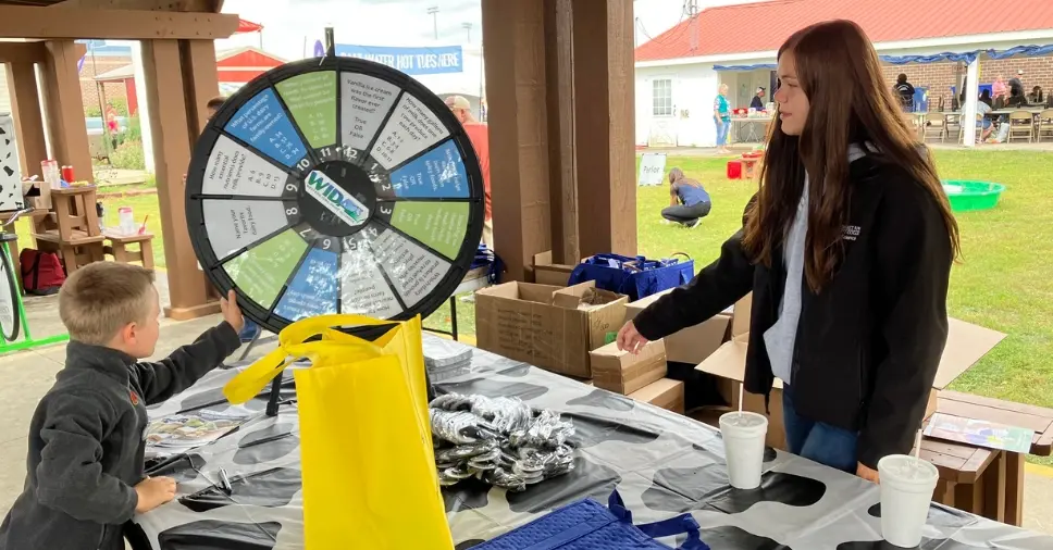 Iowa dairy ambassador playing spinning game with child