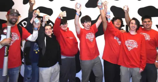 Esports students holding up chocolate milk cartons.