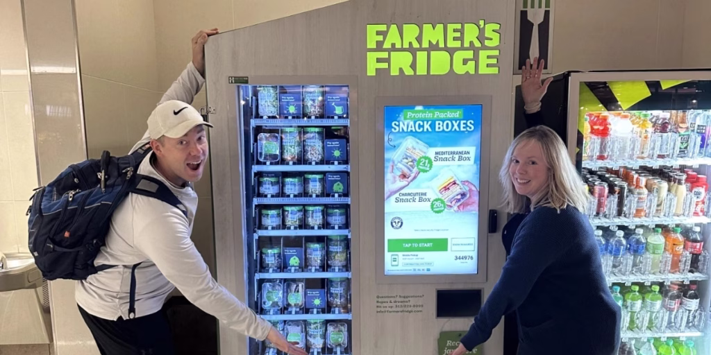 Midwest Dairy Staff showing off Farmer's Fridge display featuring dairy