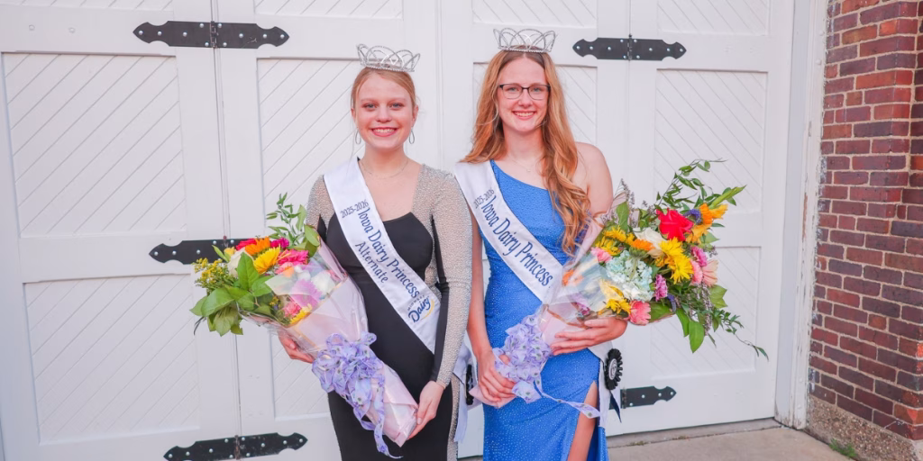 Kelsey Timp and Alia Domeyer, Iowa Dairy Princesses smiling at camera