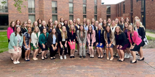 Princess Kay candidates posing outside venue.