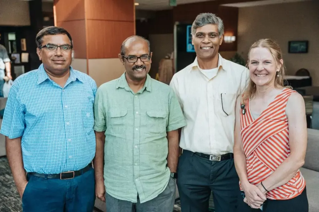 Researchers standing in a row smiling