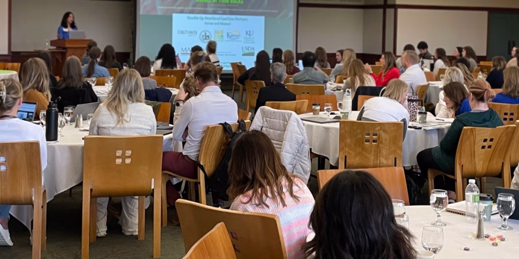 Group of meeting attendees watching a presentation.