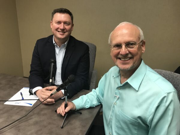 Former Midwest Dairy CEO Lucas Lentsch sits at a table, being interviewed by Dr. Jim Painter.