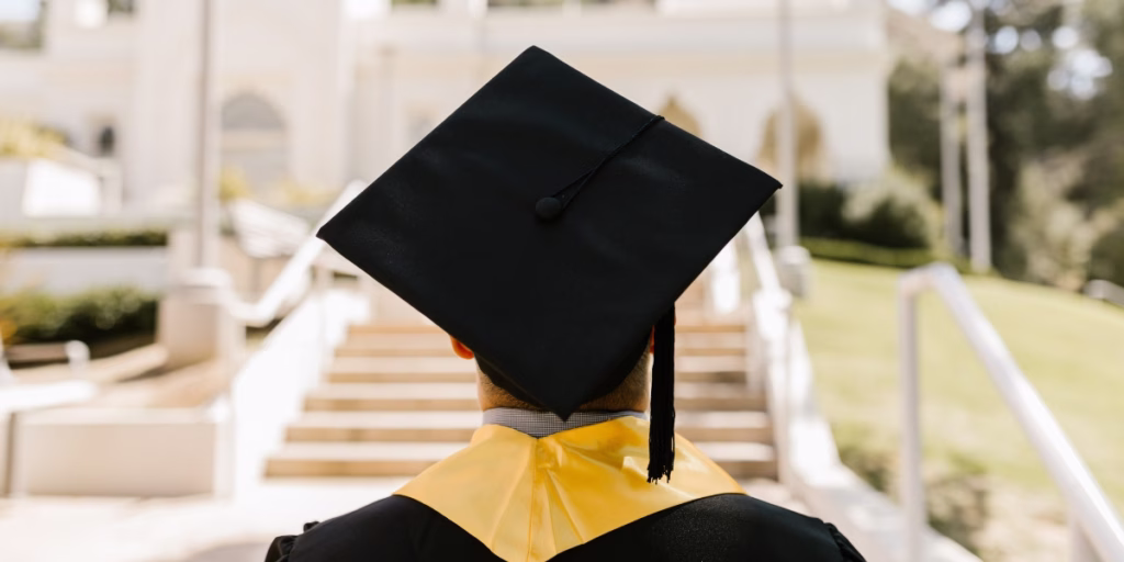 Image of the back of a graduate in their cap and gown