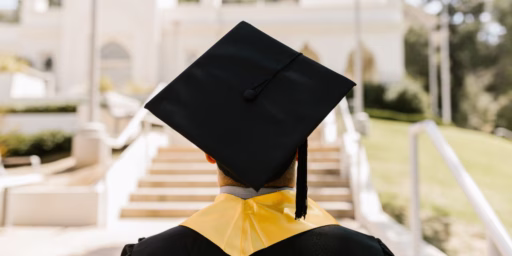Image of the back of a graduate in their cap and gown