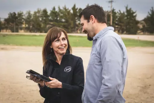 Midwest Dairy staff talking with farmer