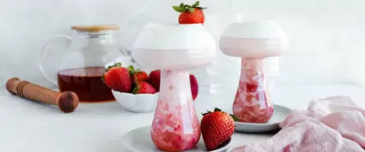 Homemade strawberry boba in a uniquely shaped glass