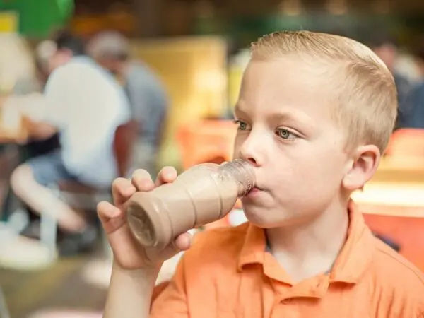 student drinking chocolate milk