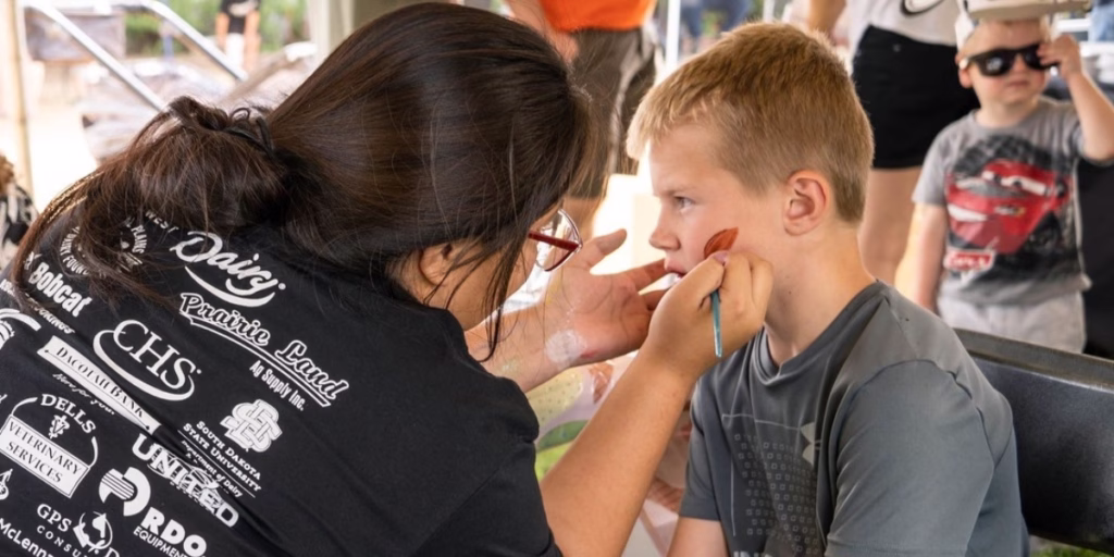 Child at event getting face painted